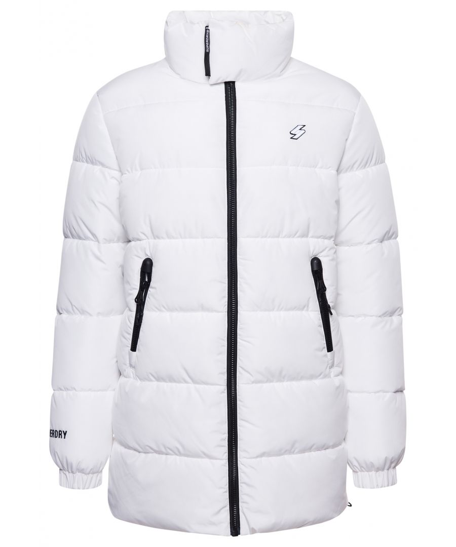 Wear something bold this season with the Longline Sports Puffer Jacket. It features comfort, style and security for both you and your belongings. Wear it over your favourite hoodie for the ultimate cosiness.Loose Fit – where comfort meets cool, a stylish loose cut makes this a must-have shapePuffer designWater repellant coatingSingle collar with hook and loop fasteningZip fasteningElasticated cuffsBungee cord waistTwo zip front pocketsInternal mesh pocketSignature Code logo badgeEmbroidered Superdry logoThe padding in this jacket is 100% Recycled Polyester – each jacket contains up to 10 recycled bottles, this avoids these bottles being sent to landfill or polluting our oceans.
