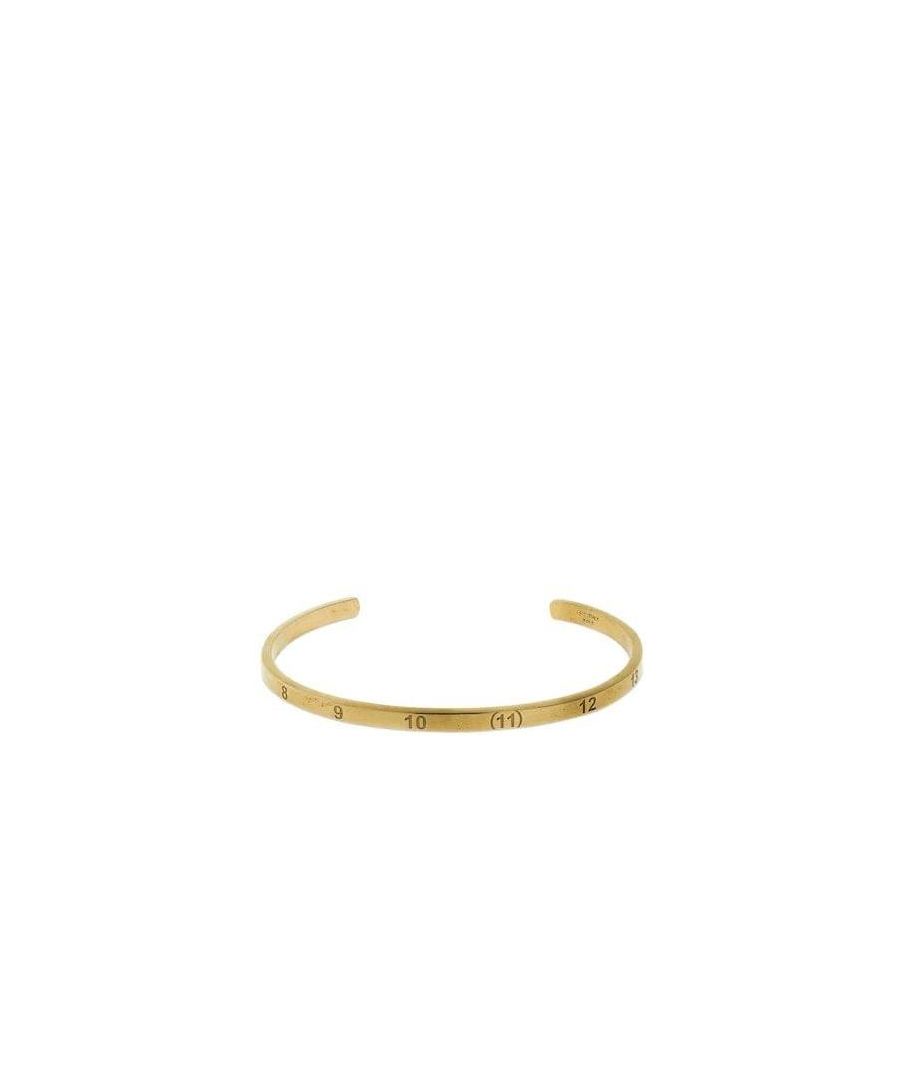 This Maison Margiela Bracelet is crafted from yellow gold plated 925 semi polished sterling silver and consists of number engraved details, logo detail and a no closure design.
