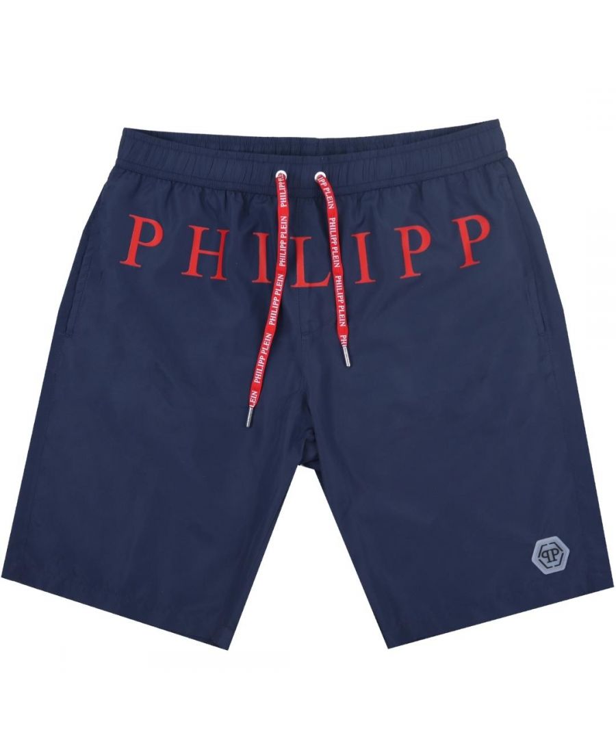 Philipp Plein Red Brand Logo Navy Blue Swim Shorts. Philipp Plein Red Brand Logo Navy Blue Swim Shorts. Elasticated Waistband. Branded Drawstring Fasten. Long Boardshort Style. Product Code - CUPP04 L0185