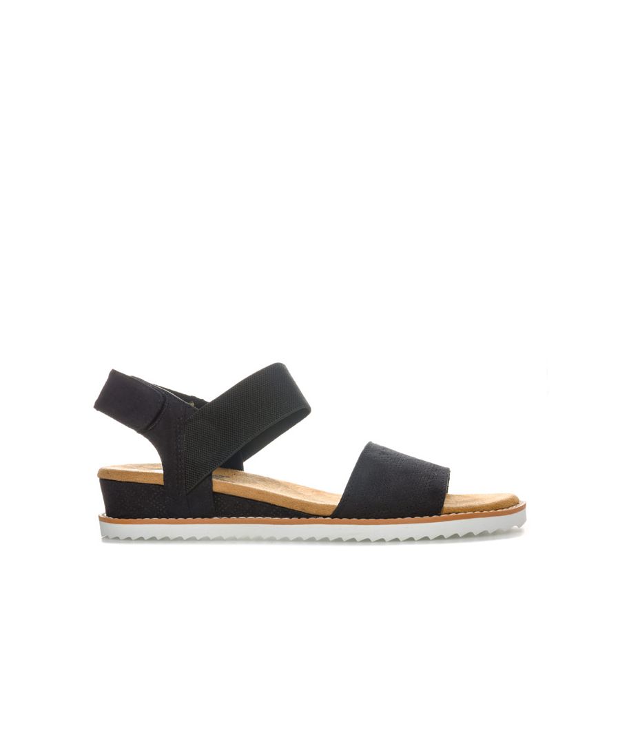 Womens Skechers BOBS Desert Kiss Sandals in black. <BR><BR>Strappy casual comfort sandals.<BR>- Soft and smooth durasuede fabric upper.<BR>- Bandage strap to front with perforated detail.<BR>- Elasticated instep ankle strap for flexible comfort.<BR>- Slingback ankle strap with hook and loop fastening for a custom fit. <BR>- Smooth fabric strap lining. <BR>- Memory Foam cushioned comfort insole.<BR>- Durasuede wrapped low wedge midsole with perforated detail. <BR>- Flexible traction outsole. <BR>- Wedge height: 3cm (1.25“) approximately.<BR>- Textile upper and lining  Synthetic sole. <BR>- Ref: 31440-BLK<BR><BR>Measurements are intended for guidance only.