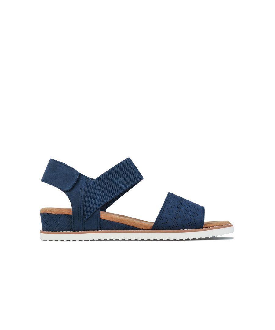 Womens Skechers BOBS Desert Kiss Sandals in navy.<BR><BR>- Soft smooth durasuede textured synthetic upper.<BR>- Strappy casual comfort sandal design.<BR>- Stitching accents.<BR>- Front slide single band with perforation accents. <BR>- Side crossing ankle sling strap with adjustable heel strap.<BR>- Stretch fabric instep ankle strap for added flexible comfort.<BR>- Hook and loop strap closure for a precise fit.<BR>- Smooth fabric strap lining.<BR>- Memory Foam cushioned and contoured comfort footbed.<BR>- Soft sueded-fabric footbed.<BR>- Durasuede wrapped low wedge heel midsole.<BR>- Stitch accented sole border trim.<BR>- Flexible rubber traction outsole.<BR>- Textile upper and lining  Synthetic sole.<BR>- Ref.: 31440NVY