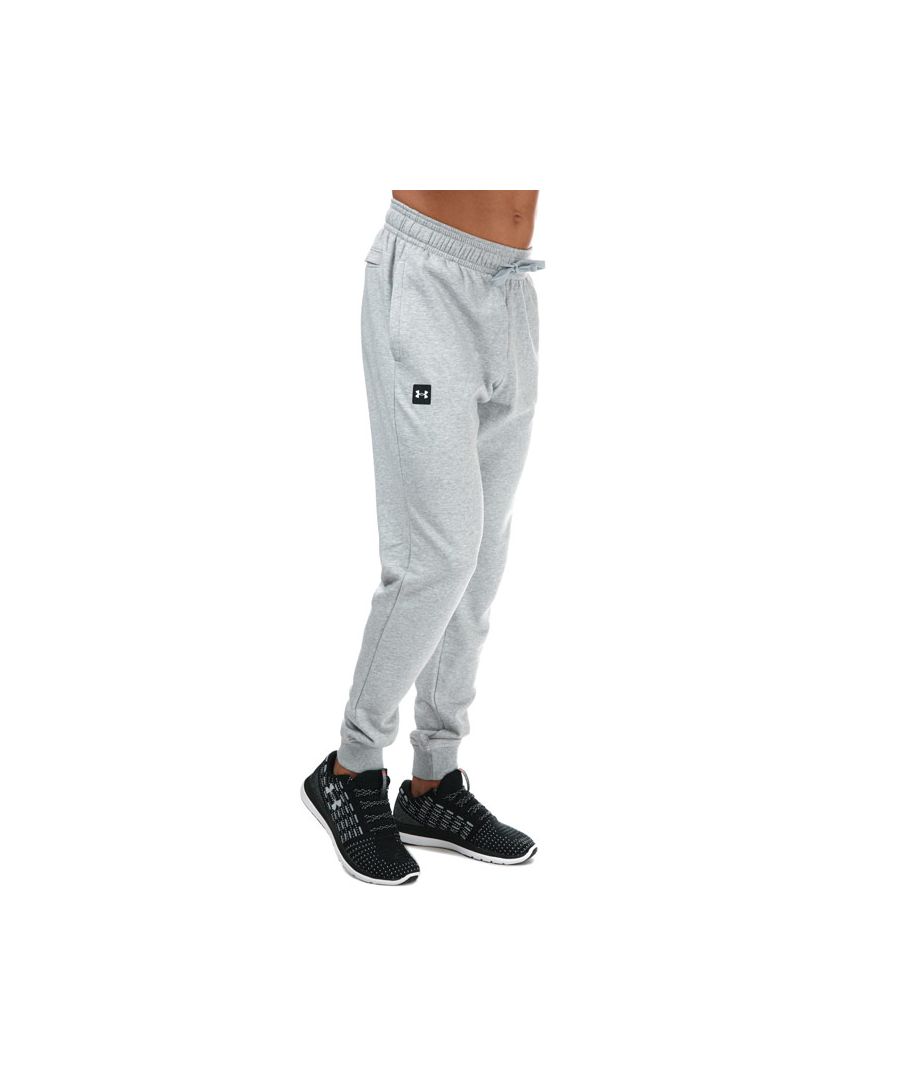Mens Under Armour Rival Fleece Jog Pants in grey.<BR><BR>- Encased elastic waistband with external drawcord.<BR>- Open hand pockets & secure.<BR>- Snap back pocket.<BR>- Ribbed cuffs.<BR>- Ultra-soft  mid-weight cotton-blend fleece.<BR>- Brushed interior for extra warmth.<BR>- 80% Cotton  20% Polyester. Machine washable. <BR>- Ref: 1357128011