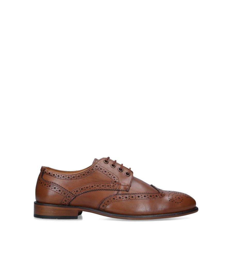 The Connor shoes are a formal men's shoe crafted from tan leather. The front is laced up simply with blind eyelets above a rounded toe with wingtip stitching. The shoe rests on a neutral brown block heel sole.