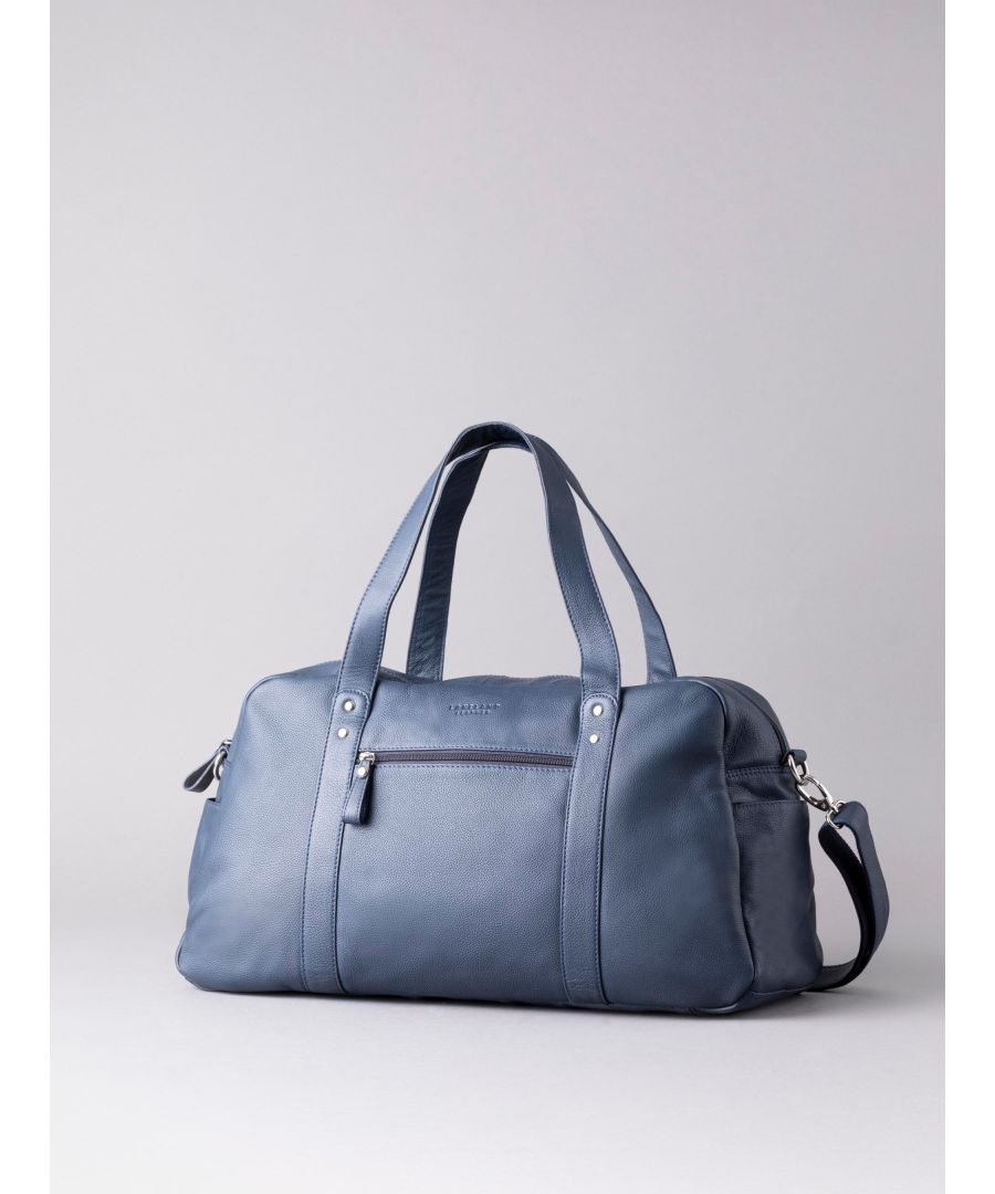 The stylish and spacious Lorton Large Leather Holdall perfect for weekends away. Crafted from premium navy leather, this holdall is complete with shoulder straps and a longer, removable and adjustable cross body strap. The spacious interior features a zip and slip pocket while the outside boasts side slip pockets and a front zip pocket for quick access essentials.