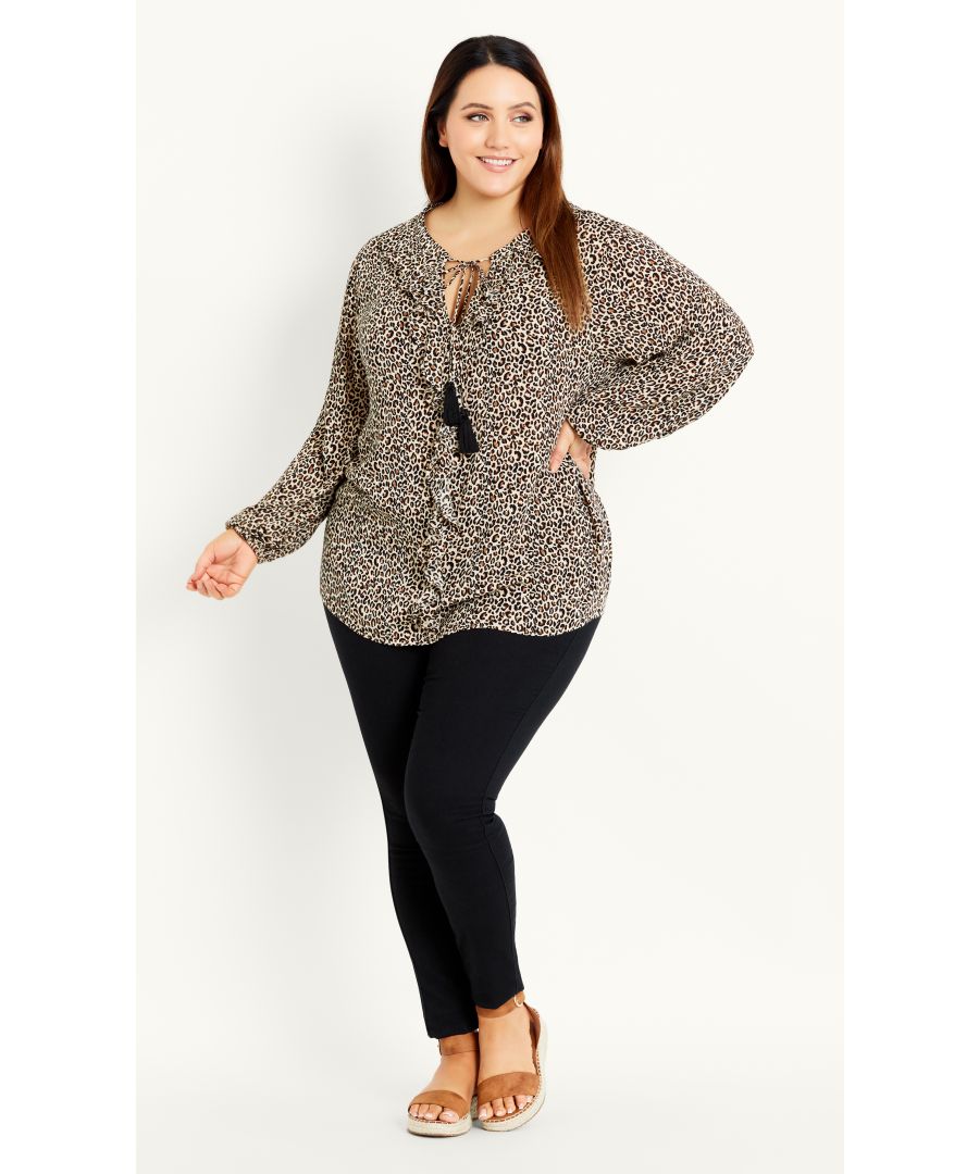 Look fierce in the Tie Neck Leopard Top, offering long sleeve coverage and a bold leopard print. Easily styled from day-to-night, this frilled blouse brings a dynamic energy to any outfit! Key Features Include: - Round tie neckline with tassel detail - Long elasticated sleeves - Frilled front - Relaxed fit - Unlined - Pull over style - Hip length Complete the look with black skinny jeans and ankle boots.