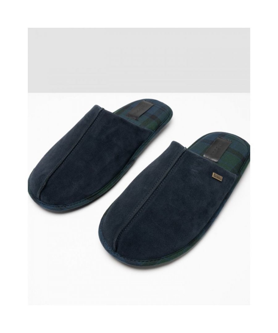 The Barbour Foley Slippers showcase a timeless design, perfect for relaxing around the house or in front of an open fire. With a tartan lining and trim, these slippers are crafted from 100% suede for a luxurious addition to laid back days. A metal Barbour branded trim effortlessly finishes off these slippers.\n• Upper: 100% Suede\n• Lining: 100% Polyester\n• Allow dirt to dry. Brush clean with a stiff brush. Spray with a Scotch guard protector.\nRegular Fit\n 