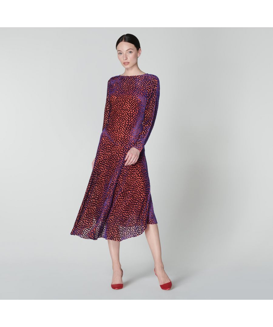 We love the textural effect of a devoré spot and have chosen a striking colour combination on our elegant Bloomsbury midi dress. With a pink base and a purple spot overlay, this beautiful dress has a slash neck, long sleeves and a playful asymmetric hemline. Wear it with sharp courts and a simple clutch.