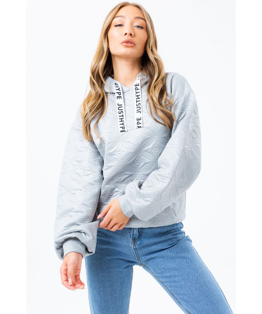 The hoodie staple you need every season. The HYPE. quilted draped sleeve women's hoodie, available in UK size 6 up to 20, creating the supreme amount of comfort you need. For a relaxed casual vibe, wear with a pair of joggers or for a smarter look, team with a floaty midi skirt and high-top kicks. Designed in a grey base with an allover textured print and contrasting white just hype logo drawstring, finished with a kangaroo pocket. Machine wash at 30 degrees.