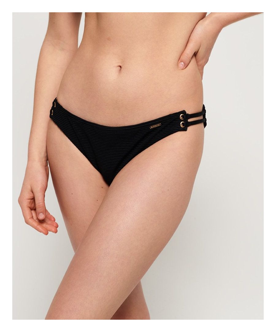 Superdry women's Alice textured cupped bikini bottoms. Make a splash this season in the Alice bikini bottoms. Classic in style, these bikini bottoms feature cut out side detailing and are completed with a metal logo badge on the waist.Matching top available.Please note, due to hygiene reasons we are unable to offer an exchange or refund on swimwear unless the hygiene strip is still intact. This does not affect your statutory rights.