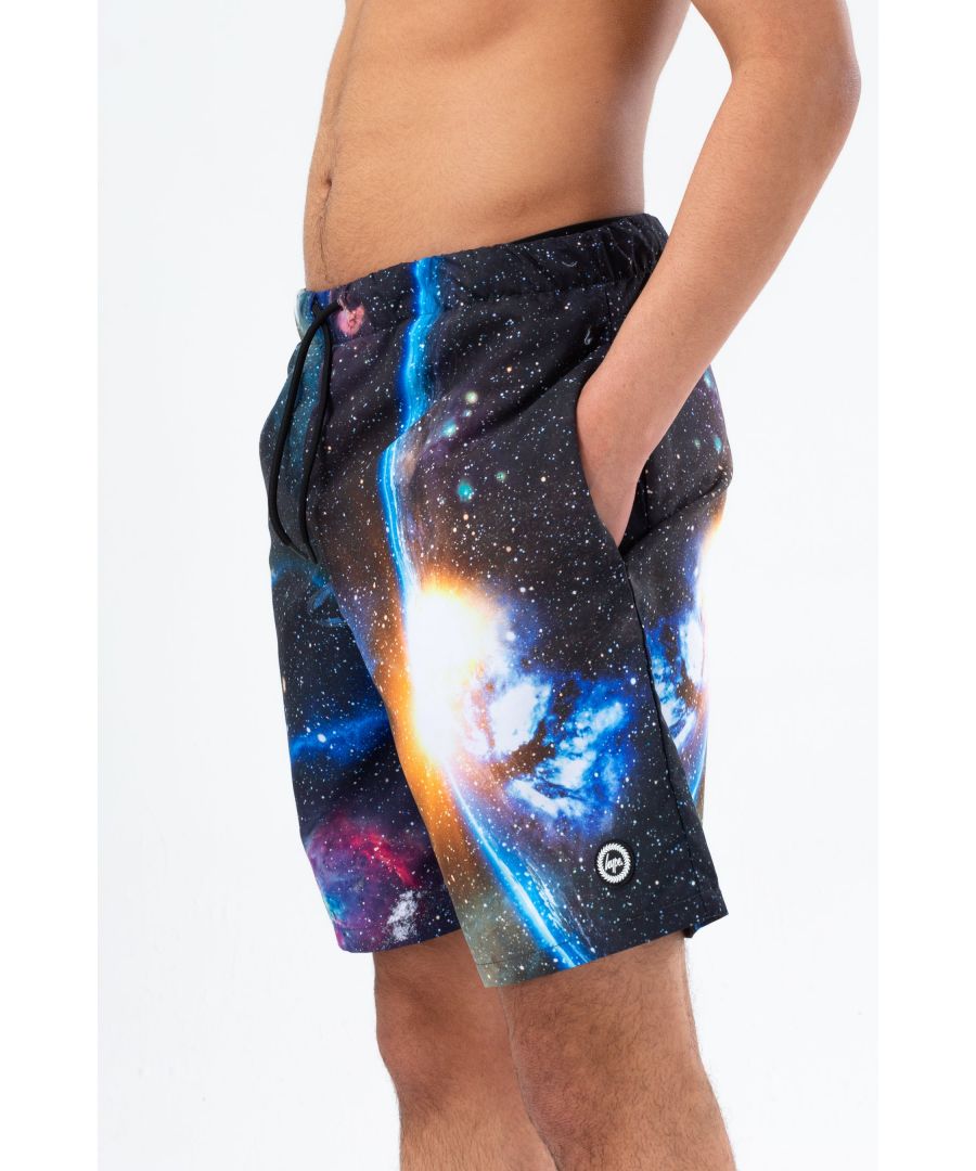 Stay cool by the pool this summer with the HYPE. Black Odyssey Crest Swim Shorts. Designed in our swimming short shape with quick-drying poly fabric, a mesh inner layer, and an elasticated waistband for a custom feel. Boasting an all-over galaxy print and rubberised HYPE. crest. 
