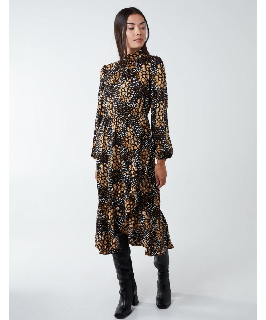 The Blouson Elasticated Wrap Midi Dress features a floral and polka dot print, a wrap bottom, and a high neck. Fancy events and date nights are right on this dress's aisle. Simply match with ankle black boots and a mini bag.