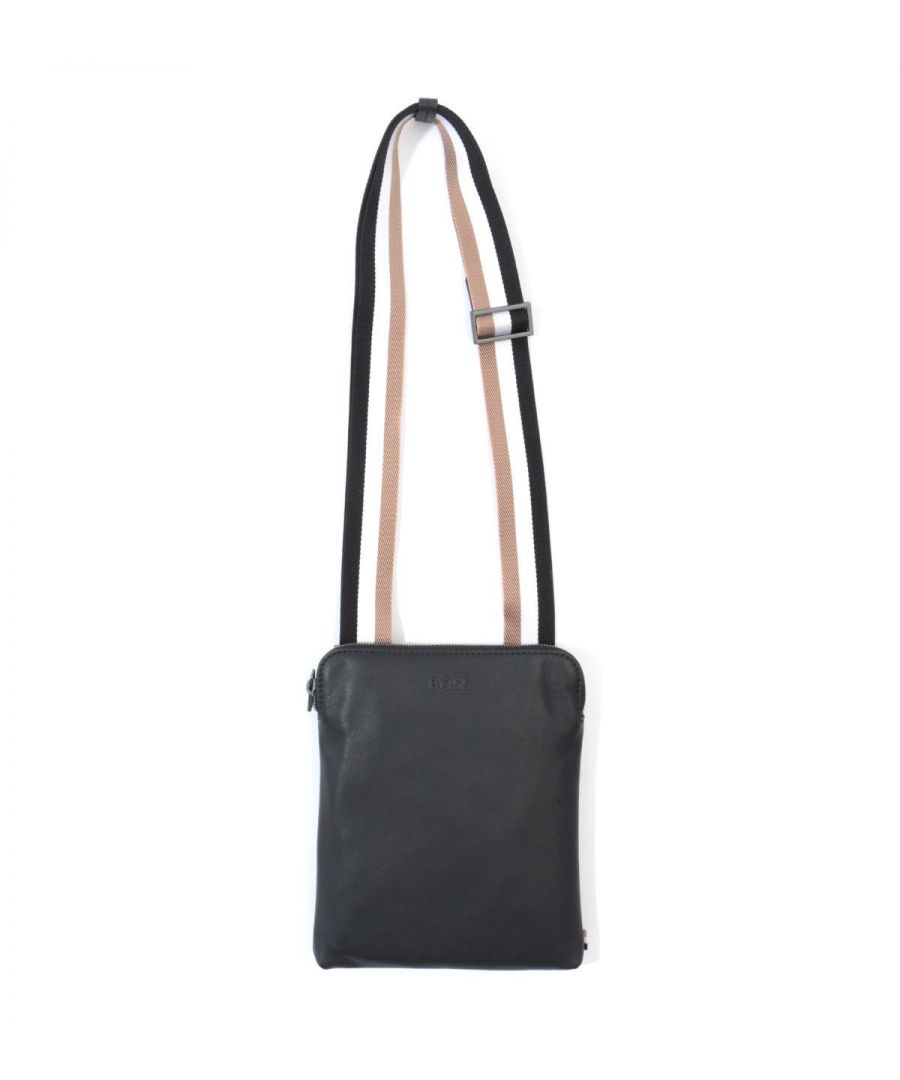 A sleek and sophisticated city essential, this leather envelope crossbody bag from BOSS is crafted from premium sustainable Italian Leather in a matte effect. Featuring a main zip compartment with an internal zip pocket, rear open open and an adjustable webbing strap that boasts their signature stripes. Finished with a subtle BOSS logo debossed at the front. A minimum of 60% of the leather used to make this product has been sourced from certi?ed tanneries using low-impact methods, for a reduced impact on the environment. By purchasing this product, you are supporting responsible leather manufacturing through the Leather Working Group (LWG)Sustainable Italian Leather, Main Zip Compartment, Internal Zip Pocket, Rear Open Pocket, Signature Stripe Adjustable Webbing Strap, Brushed Gunmetal Hardware, Dimensions: 20 x 24 x 1.5 cm, BOSS Branding.