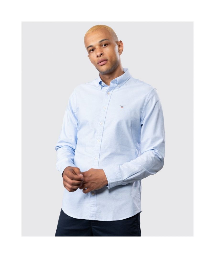 Our bestselling cotton oxford shirt. This slim fit shirt features our signature button-down collar, the locker loop at the back, and our classic shield logo embroidered at the chest.\n\nSlim fit\nButton-down collar\nGANT logo embroidery at chest\nMaterial: Cotton 100%\n\n \nItem No. 3046002