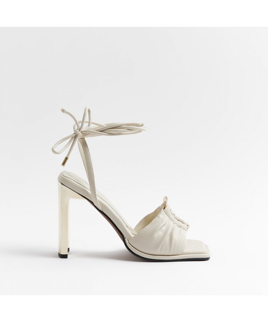 > Brand: River Island> Department: Women> Colour: Cream> Type: Heel> Style: Strappy> Material Composition: Upper: PU, Sole: Plastic> Upper Material: PU> Occasion: Casual> Season: AW22> Closure: Tie> Toe Shape: Open Toe> Heel Style: Block> Heel Height: High (7.6-10 cm)