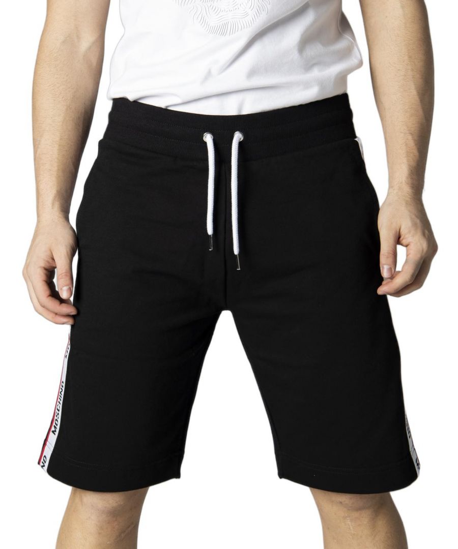 Moschino Branded Tape Logo Black Shorts. Moschino Black Shorts. Tape Logo Down Legs, Elasticated Waist. 95% Cotton, 5% Elastane, Back Pocket. Drawstring Ties, Moschino Loungewear Collection. Style Code: A4306 8102 0555