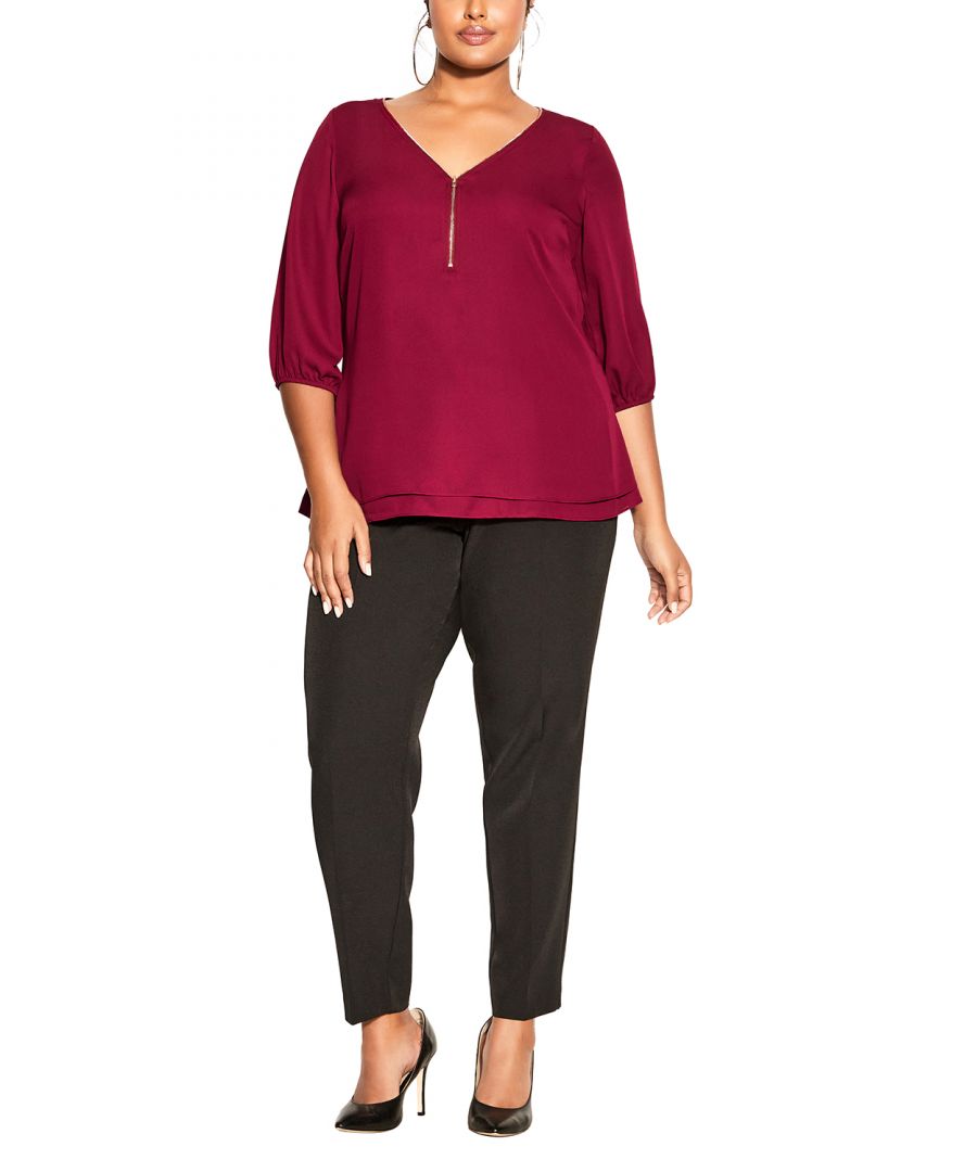 Flaunt your fierce fashion sense in the sangria Sexy Fling Elbow Sleeve Top. Featuring a flattering v-neckline with a working zip, relaxed fit and elbow length sleeves, this top is a perfect addition to your everyday collection. Key Features Include: - Workable zip neckline - Darted bust - Double layer front - 3/4 sleeve with elastic cuff - Relaxed fit - Hip length hemline - Lightweight woven fabrication