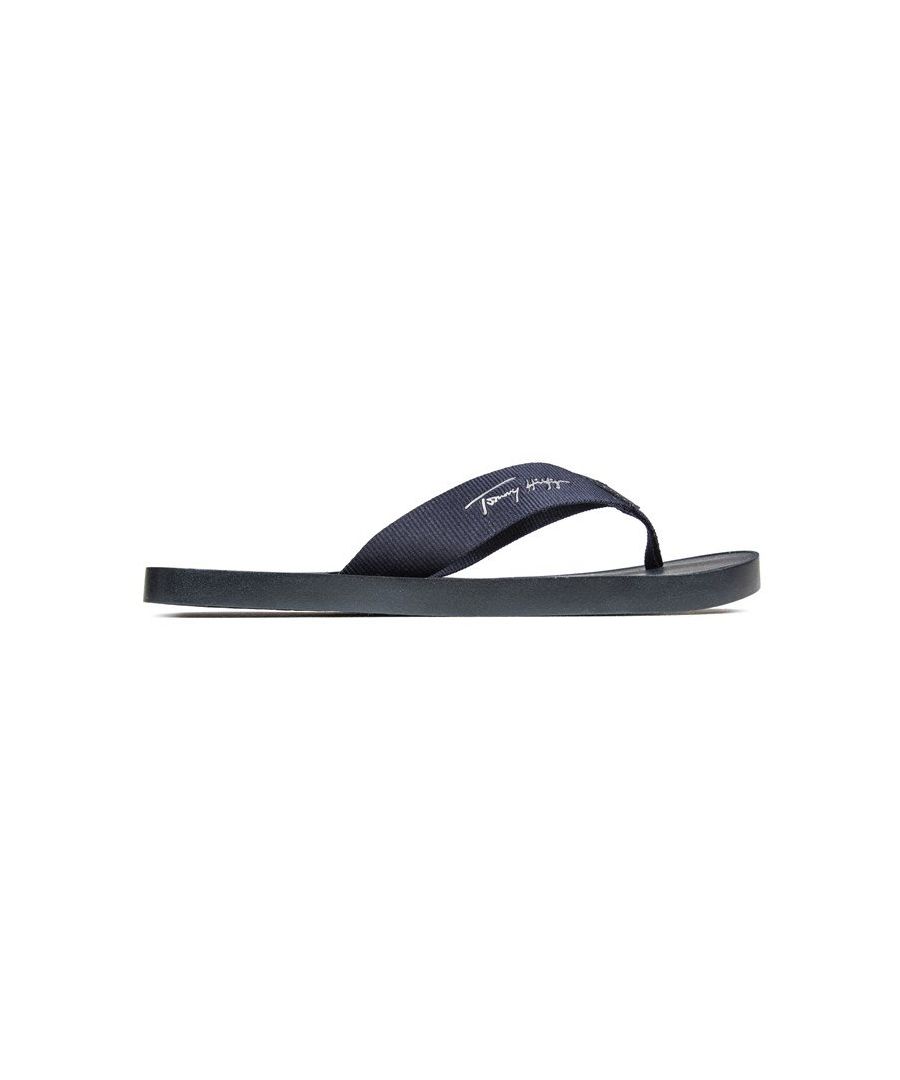 Women's Navy Tommy Hilfiger Flat Beach Slip-on Sandals With Soft Nylon Thong Strap Featuring Leather Logo Tab And Branding In White To Strap And Footbed. These Ladies Flip Flops Have An Eva Comfort Sole With Branded Initial Tread For Grip.