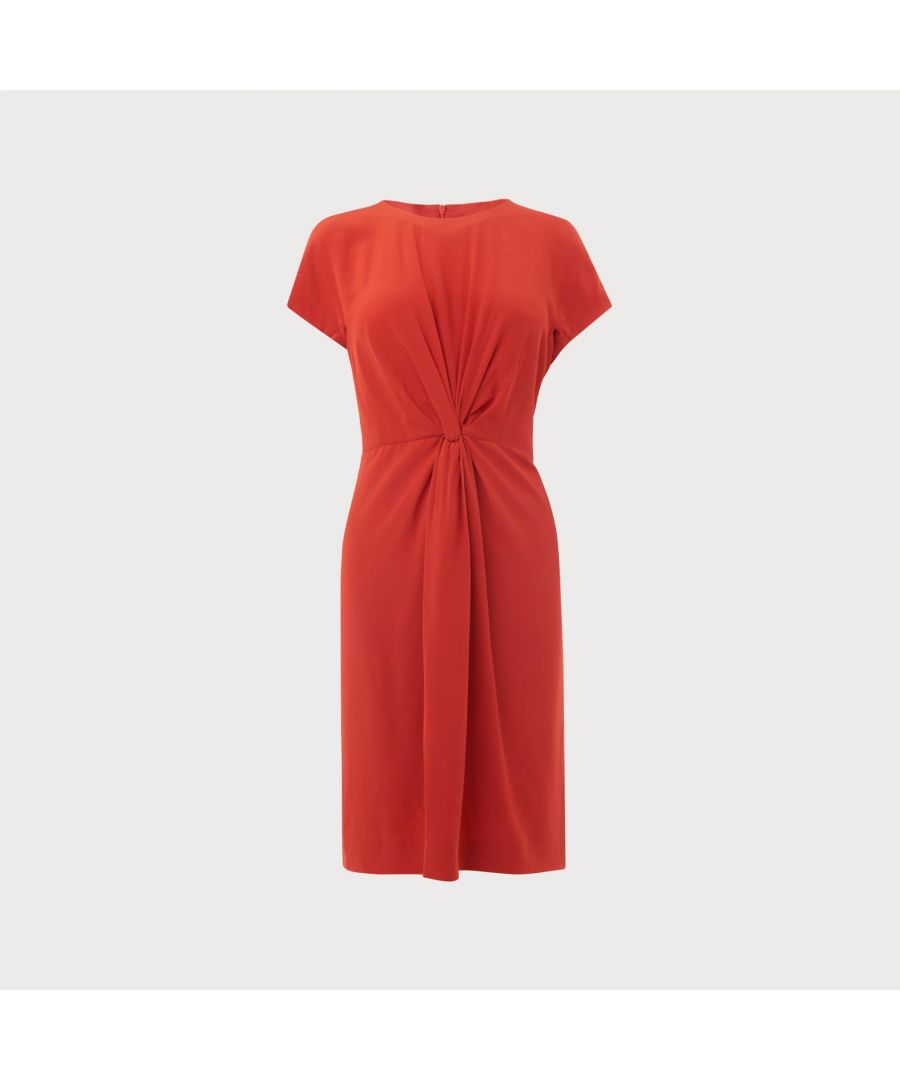 Crafted from pure silk, Milas in poppy red is a luxurious summer dress that will slot seamlessly into your workwear wardrobe. Perfect for the office as well as special occasions, this short sleeve dress features knot detail to the front elegantly cinching the waist and fastens to the back with a concealed zip.