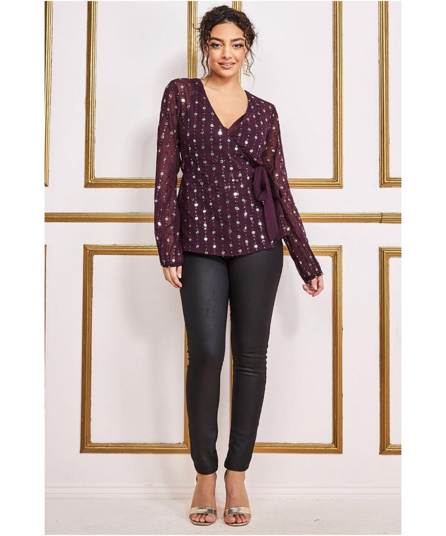 This top is for anyone who loves to be the centre of attention. Its gold sequin pattern will make you sparkle, and its classic wine colour will help you stand out from the crowd. You can pair it with a pencil skirt or black cigarette pants, or wear it with a pair of smart trousers to impress your colleagues at work. This dark red top is designed to make you feel on top of your fashion. The front wrap detail and sequin work on the back give it a very feminine look. The deep neckline will show off your décolletage while the cami provides some modesty. Wear this with a pair of leather leggings or smart trousers for an evening event, or with a pair of smart black trousers for an important meeting