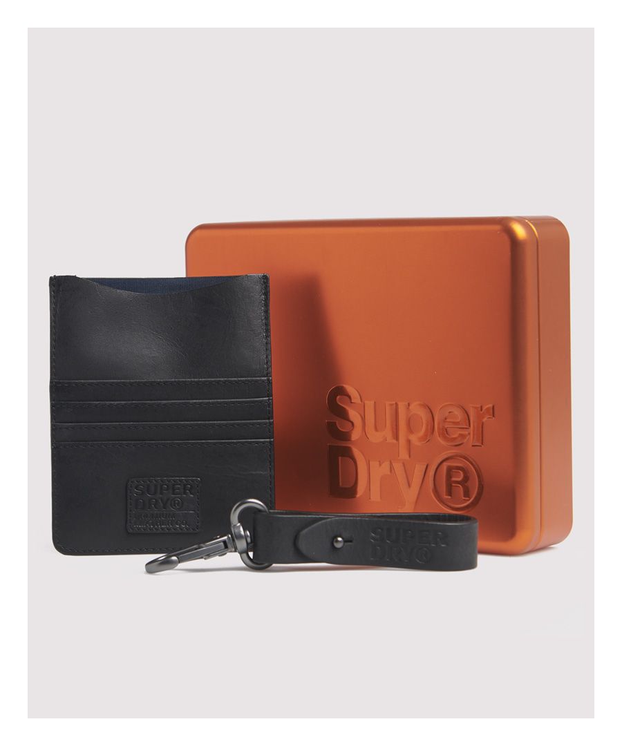 Superdry men's Leather travel wallet set. This simple and elegant leather wallet features a large pouch for notes and receipts, four card slots on the front, and a final one on the back. Perfect for the guy who doesn't like to carry loose change, the Leather travel wallet is designed to only hold cards and notes and fits into a back pocket or a coat pocket. The set also comes with a leather keyring featuring a clasp so you can attach it to your belt loop, bag, or backpack.H: 13cm (5