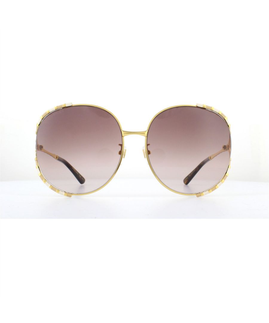 Gucci Sunglasses GG0595S 008 Gold and Ivory Brown Gradient are an ultra feminine and unique design. The signature Gucci bamboo design is featured around the outer edge of each lens and along the temples. The bamboo effect is striped with enamel creating contrasting tones to ensure you stand out from the crowd. Interlocking GG logos are presented on each hinge.
