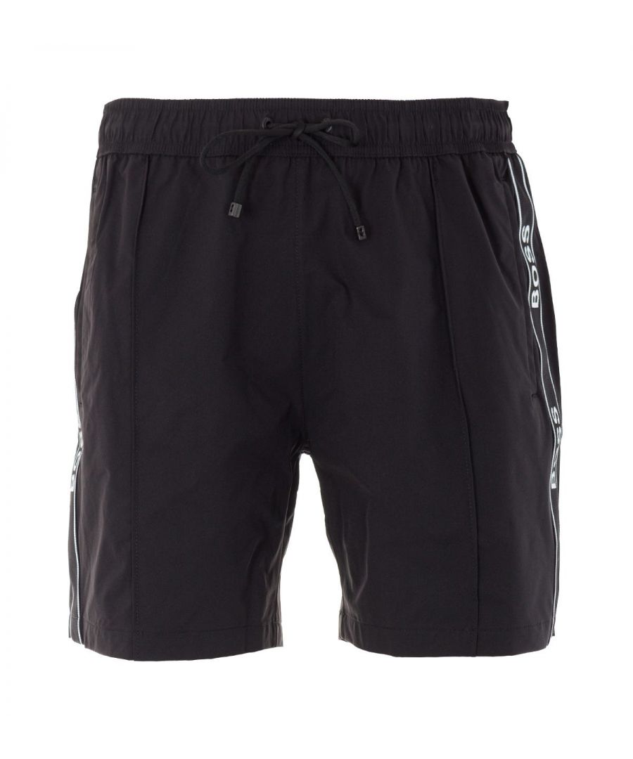 These modern swim shorts from BOSS are crafted from quick-drying fabric made from pure recycled polyester allowing you feel good about yourself and the planet whilst swimming in style. Featuring an elasticated drawstring waistband with twin slit pockets and a rear flap pocket. Finished with branded contrast jacquard-woven tape to the seams and rear. Regular Fit, Quick Dry Recycled Polyester, Mesh Lining, Elasticated Drawstring Waist, Twin Side Slit Pockets, Rear Flap Pocket, BOSS Branding. Style & Fit: Regular Fit, Fits True to Size. Composition & Care: 100% Recycled Polyester, Machine Wash.