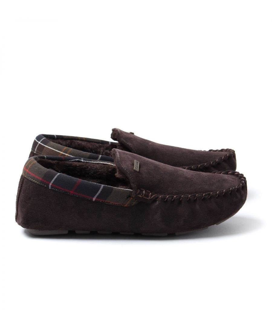 Relax in style with the Monty Slippers from Barbour. Crafted from supple suede and trimmed with their signature Tartan. Featuring a cosy faux fur lining providing comfort and warmth. Finished with the signature Barbour branding. Suede & Cotton Uppers, Faux Fur Lining, Signature Tartan Trims, Rubber Sole, Barbour Branding.