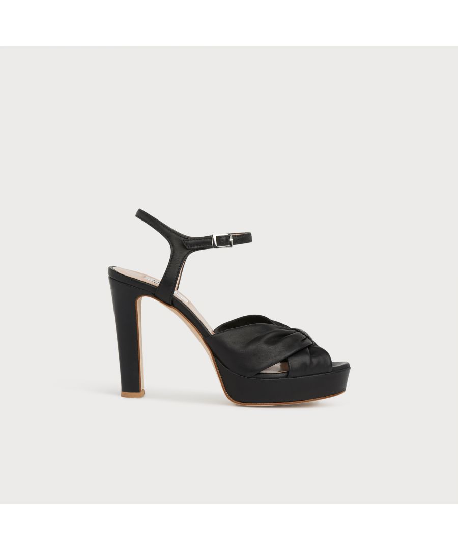 Seventies-inspired and statement-making, our Nille platforms are perfect for the season's parties and special occasions. Crafted in Italy from beautiful black nappa leather, they have a knotted front, platform soles, ankle straps and a slender but substantial 140mm heel. Wear them with party dresses and have some fun.