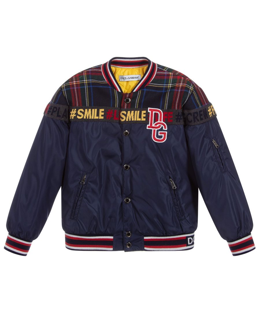 This Dolce & Gabbana Kids padded bomber Jacket in navy, features a multi-coloured tartan trim across the shoulders, with a mutli-coloured striped jersey trims on the collar, cuffs and hem, a red and white logo on the chest and a popper fastening closure.