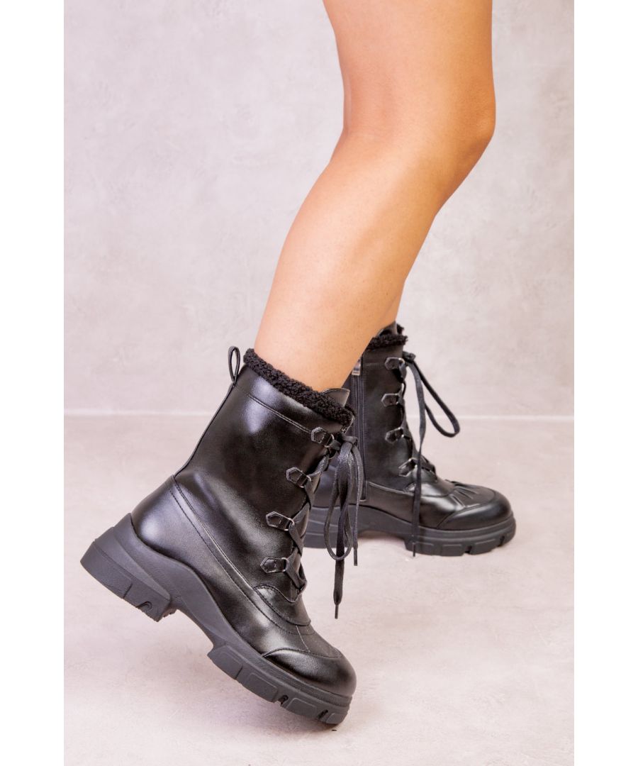 Women's faux leather mid anklechunky boots featuring front lace up and faux fur trim lining.