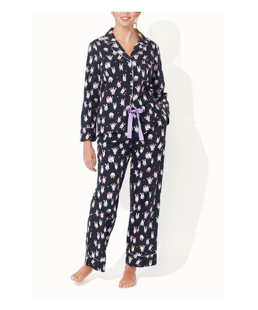 Our classic-cut pyjamas are crafted from soft, breathable cotton with an elasticated waist and a traditional style that's gently tailored for a comfortable fit,  featuring our playful Dreamgifters print on a navy backdrop. There’s a contrasting lilac piping trim, and a bow at the waist,  as well as a patch pocket on the shirt and pockets at the hip. A perfect treat for you or a heartfelt gift to someone special.