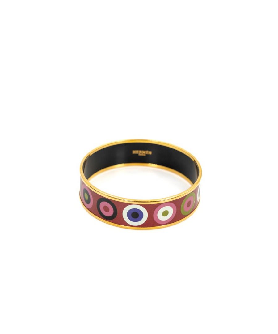 VINTAGE. RRP AS NEW. The bangle is red enamel with a multicoloured circle print and gold edges.\n\nThe inside of the bangle is black.\n\nVery good condition (8.5/10). There are slight scratches on some circles which are not noticeable when worn.