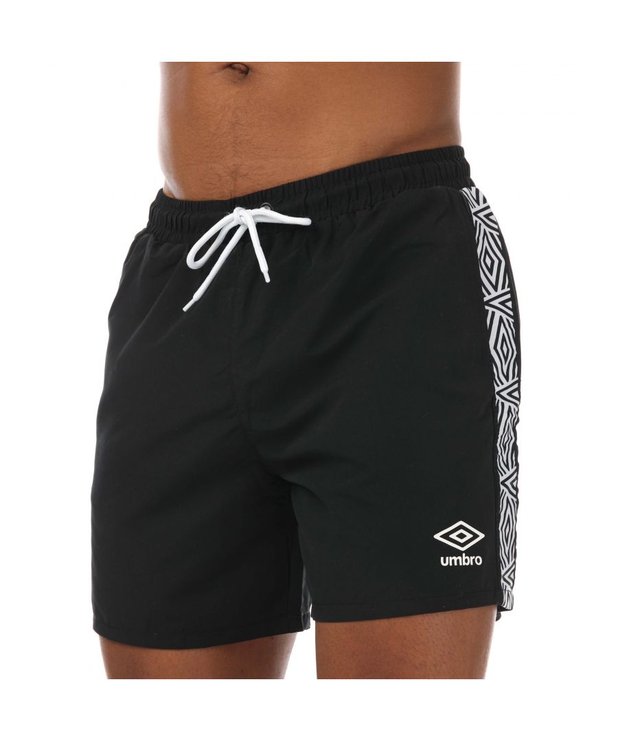 Mens Umbro Taped Swim Shorts in black.- Elasticated bungee hang loop to TW Navy rear external waistband.- Side slip pockets.- Lock zip pocket.- Internal small items storage pouch with velcro fasten.- Contrast mesh jonk.- Woven diamond pattern.- Tape running down side legs.- Contrast high build Performance Logo print to leg.- Contrast piping to rear auto.- 100% Polyester.- Ref: UMSH0205060BLK