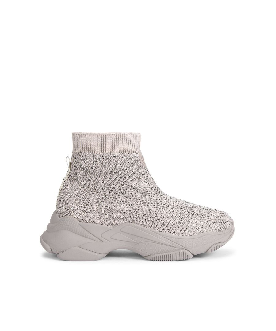 The Lila Hi Top Bling sneaker arrives in taupe with crystals across the upper. There is a KG Kurt Geiger logo tab printed on ribbed textile with a print stitch detailing at the ankle as well as rubber monocle on the front of the ankle.
