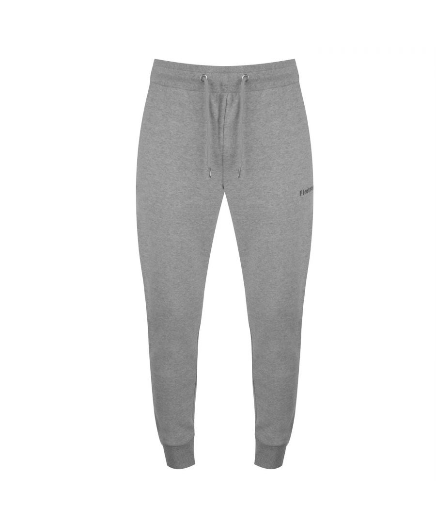 <h2>Firetrap Slim Joggers</h2>\nKeep things casual with the Slim Joggers from Firetrap. Crafted with an adjustable drawstring waist and 2 zip pockets. The look is completed with the Firetrap branding.\n\n> Men's Joggers\n> Adjustable Drawstring Waist\n> Elasticated Trims\n> 2 Zip Pockets\n> Rubber Logo\n> Firetrap Branding\n> 80% Cotton, 20% Polyester\n> Keep Away From Fire