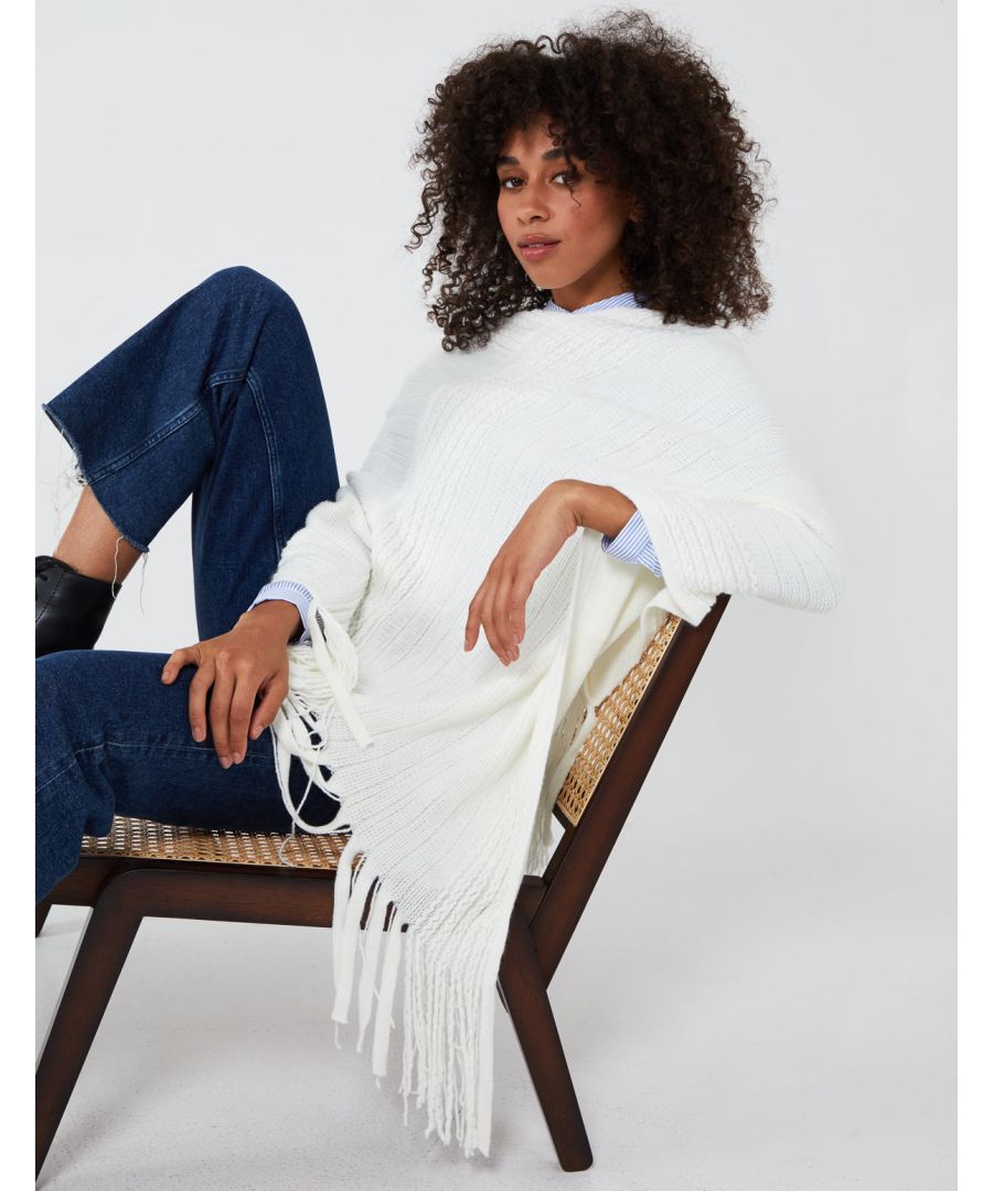 Keep warm in this season with our ribbed fringe hem poncho. Soft fabrics and oversized style will going to help you keep this winter warm and cosy. Match with pair of jeans and sneakers for casual look. \n100% Acrylic Machine washable V neckline  Approx.90 cm UnfastenedThis item is a ONE size that fits UK 8-14