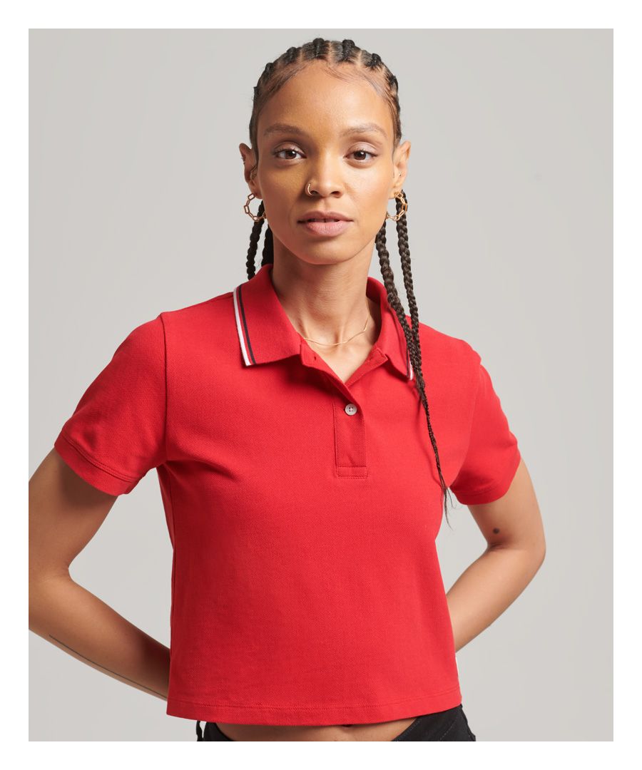 The polo shirt is a timeless staple, bringing a comfortable style to your wardrobe and casual day-to-day wear. We've taken the classic design a step further with a bold crop, adding a whole new chic to your retro styling options. Embrace the vintage look with a contemporary charm.Slim fit – designed to fit closer to the body for a more tailored lookHalf-button fasteningShort sleevesSignature Superdry patchMade with cotton in conversion.To support farmers on their three-year journey to organic certification, we have introduced ‘Cotton in Conversion’, produced using strict organic farming guidelines, and helping farmers to sell their crops for a premium during this process.