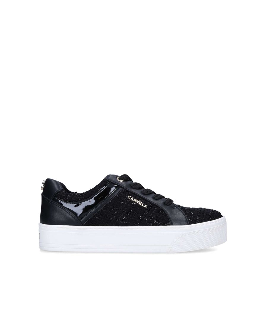 The Park is a lace-up trainer. The upper is in a black tweed fabric with patent panels. There is a branded gold tone plate at the laces and Icon C pin stud at the back of the ankle.