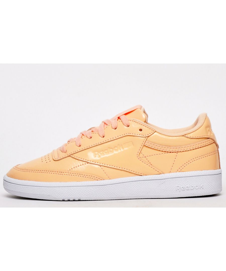 This updated version of the original Classic Leather has been enhanced with chic modern design elements for a look that is fashion forward and bang up to date. The Reebok Classic Club C 85 is made in a high-quality premium patent leather upper in an on-trend peach pink finish. These Reebok Classic C 85s are a stunning addition to your casual wardrobe and affirms its heritage with Reebok Classic branding on the woven label to the tongue, debossed to the heel and finished with branding on the side. Renowned for their timeless classic designs that never go out of style Reebok womens trainers are the ultimate in retro footwear but they also combine classic Reebok styling with inspirational design elements, proving that the Reebok brand is one that is versatile and always gives people exactly what they want. \n - Patent leather upper\n - Soft padded heel and ankle collar \n - Vintage styled wrap around outsole\n - Cushioned midsole \n - Reebok Classic branding throughout