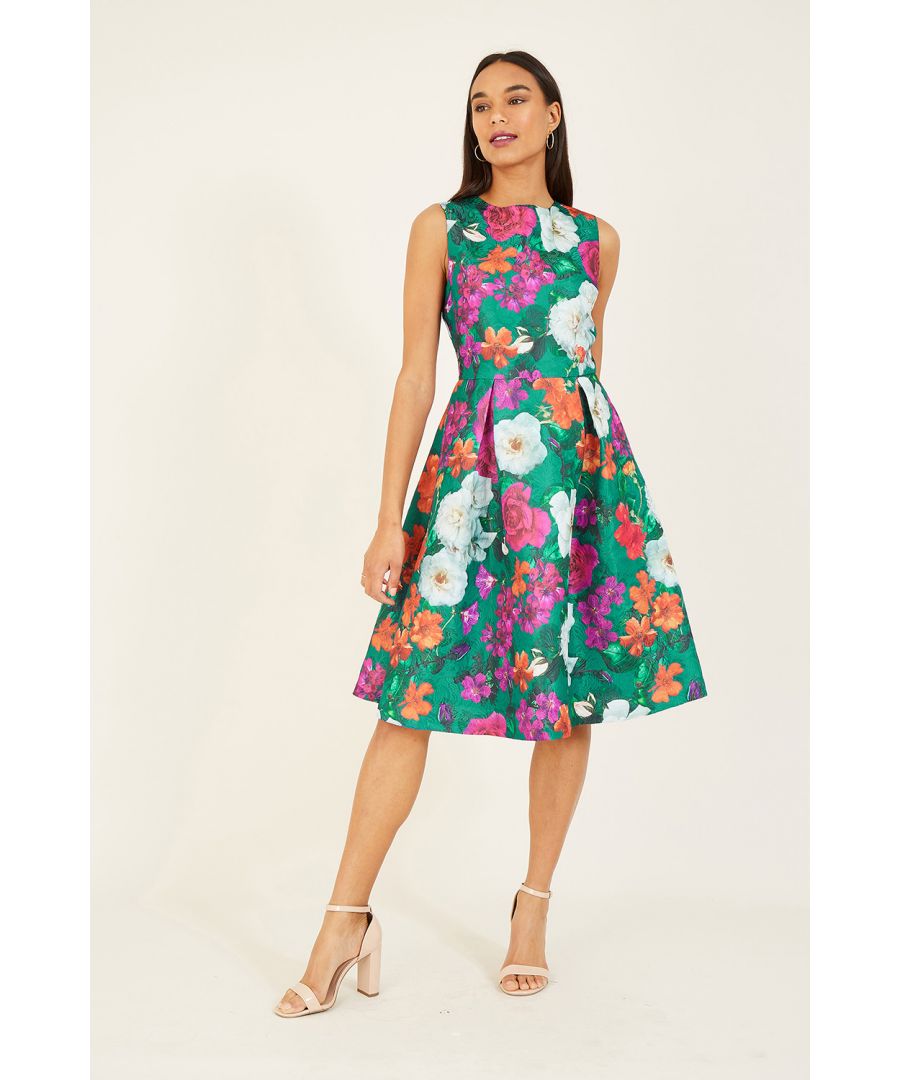 Exclusively designed in-house, this Yumi Floral Jacquard Dress. Adorned with a vibrant display of floral blooms, this fit and flare dress offers a feminine silhouette with the structured pleats. The jacquard fabric lends an elegant edge, complemented by the heavyweight fabric and fitted bodice. A zip glides up the back to finish.