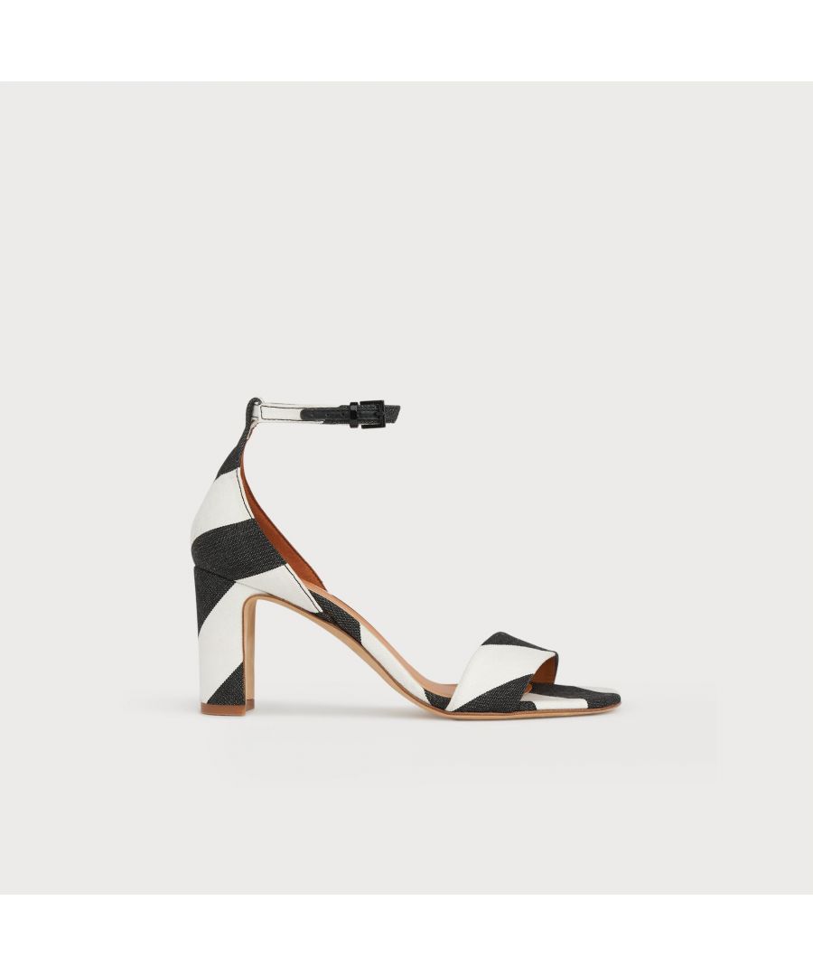 The perfect pair of everyday summer heels, our Nissi sandals go from day to night with ease. Crafted in Spain from black and white diagonal stripe fabric - which matches to pieces in our clothing collection - they have a wide strap over the toes, a covered back of heel, buckle ankle strap and a 75mm block heel. Wear them with the matching Lucia clutch and a summer dress when flats won't do.
