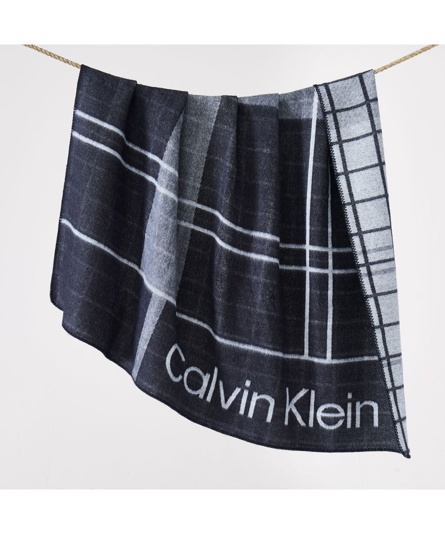 This Calvin Klein Offset Plaid Logo Throw features a woven Jacquard Plaid with Calvin Klein logo and has a 100% Acrylic knit ground. It reverses to a checkered pattern  and can be paired with matchin Offset Plaid cushion.