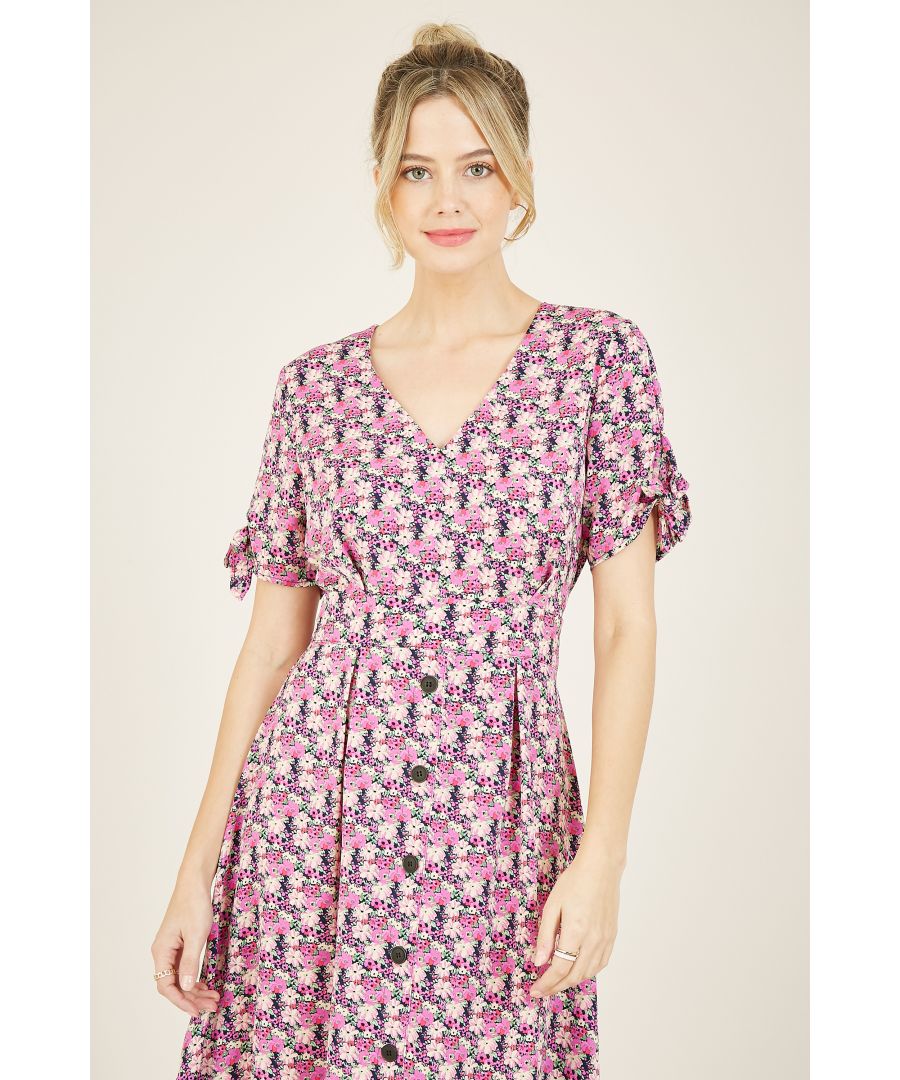 Scattered with a bright floral print, this Yumi Floral Retro Midi Dress is ideal for warmers days at home or away. It features short, flared sleeves with pretty ties for a contemporary feel and buttons running down the skirt to give you a smart feel. The fitted waist lends a nipped-in silhouette, to keep your look smart for work and fun for the weekend. The floral printed fabric is both structured and light to keep you comfortable all day long. Style with trainers or colour pop espadrilles depending on your diary.  100% Polyester Machine Wash At 30 Length is 110cm-43.3inches