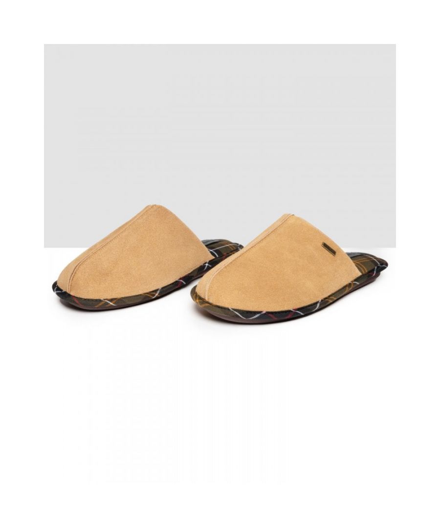 The Barbour Foley Slippers showcase a timeless design, perfect for relaxing around the house or in front of an open fire. With a tartan lining and trim, these slippers are crafted from 100% suede for a luxurious addition to laid back days. A metal Barbour branded trim effortlessly finishes off these slippers.\n• Upper: 100% Suede\n• Lining: 100% Polyester\n• Allow dirt to dry. Brush clean with a stiff brush. Spray with a Scotch guard protector.\nRegular Fit\n 