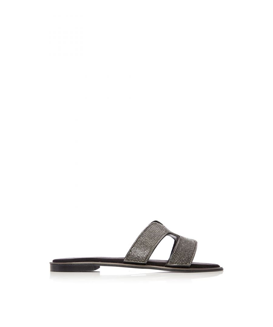 Upgrade your flats collection with Ormay. This simple H band mule is covered in stunning hot stones, perfect for adding a touch of sparkle to your outfits. The metallic rand adds further detail whilst still leaving them effortless to style. Complete with a soft sock and leather lining. Style with cropped jeans and a blouse for a chic day look.