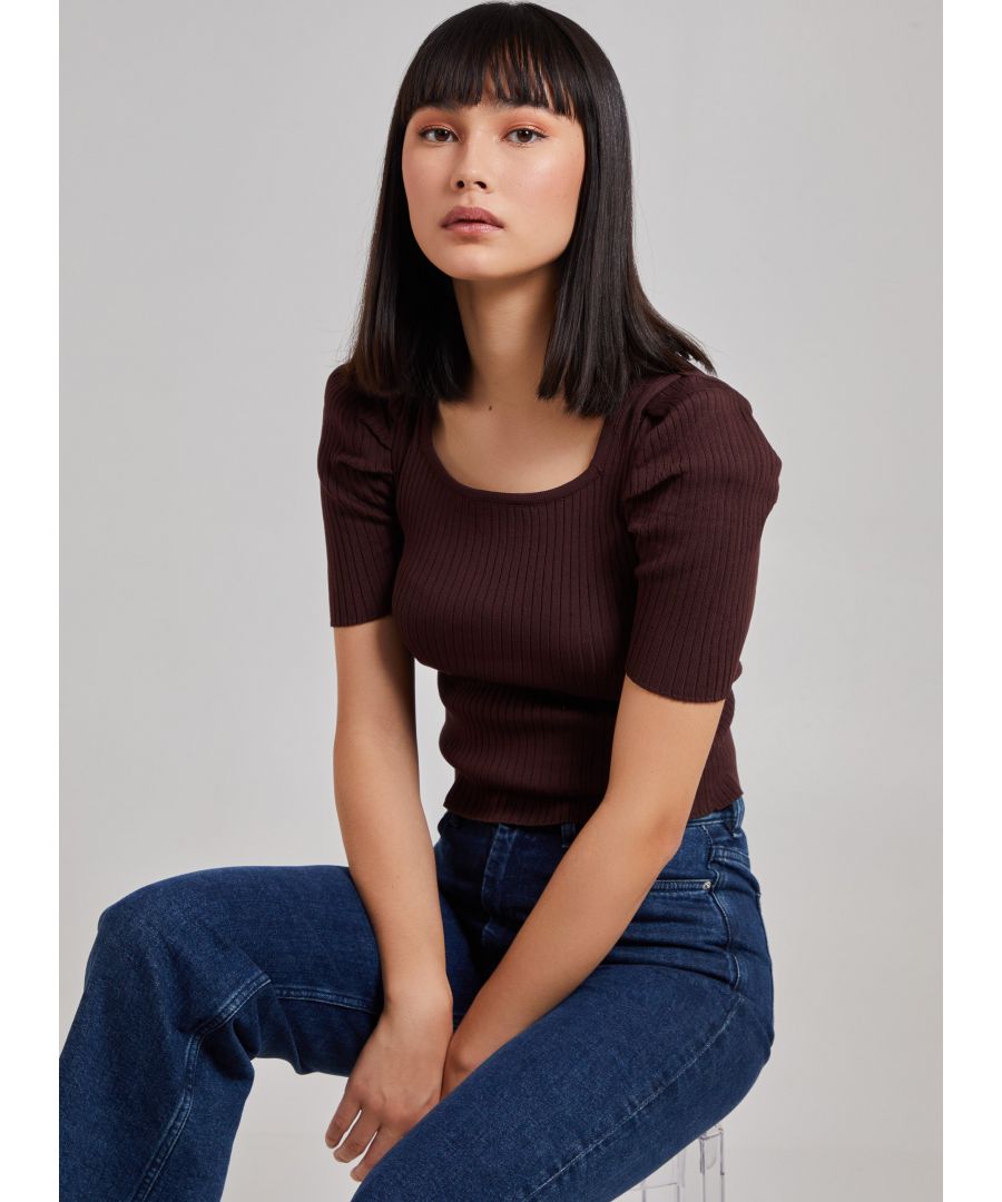 Work your styling techniques to make this top suit any occasion. Featuring a ribbed material with short puff sleeves and a cropped length. 100% Viscose. Wash With Similar Colour. Dry Flat, Iron On Reverse
