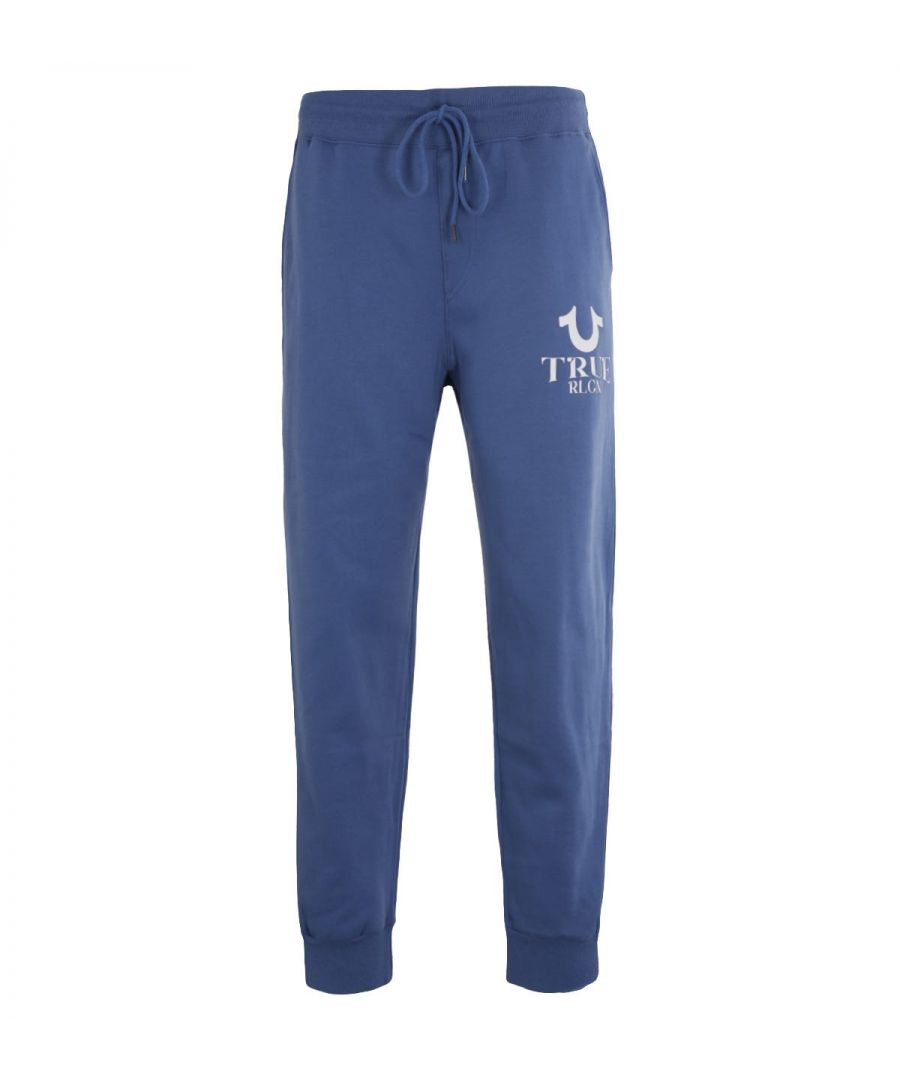 L.A fashion brand  True Religion has become a global denim expert that has redesigned and reinvented the traditional five-pocket jean. They quickly became known for quality craftsmanship  bold designs and the iconic lucky horseshoe logo.The HD Logo Joggers boast their bold designs with supreme comfort. Crafted from a soft cotton blend  in a classic sweatpants design. Finished with an iconic True Religion logo printed on the left leg in a raised HD effect.-Regular Fit-Cotton Blend Composition-Adjustable Drawstring Waist-Twin Side Entry Pockets-Rear Patch Pocket-Elasticated Cuffs -True Religion Branding