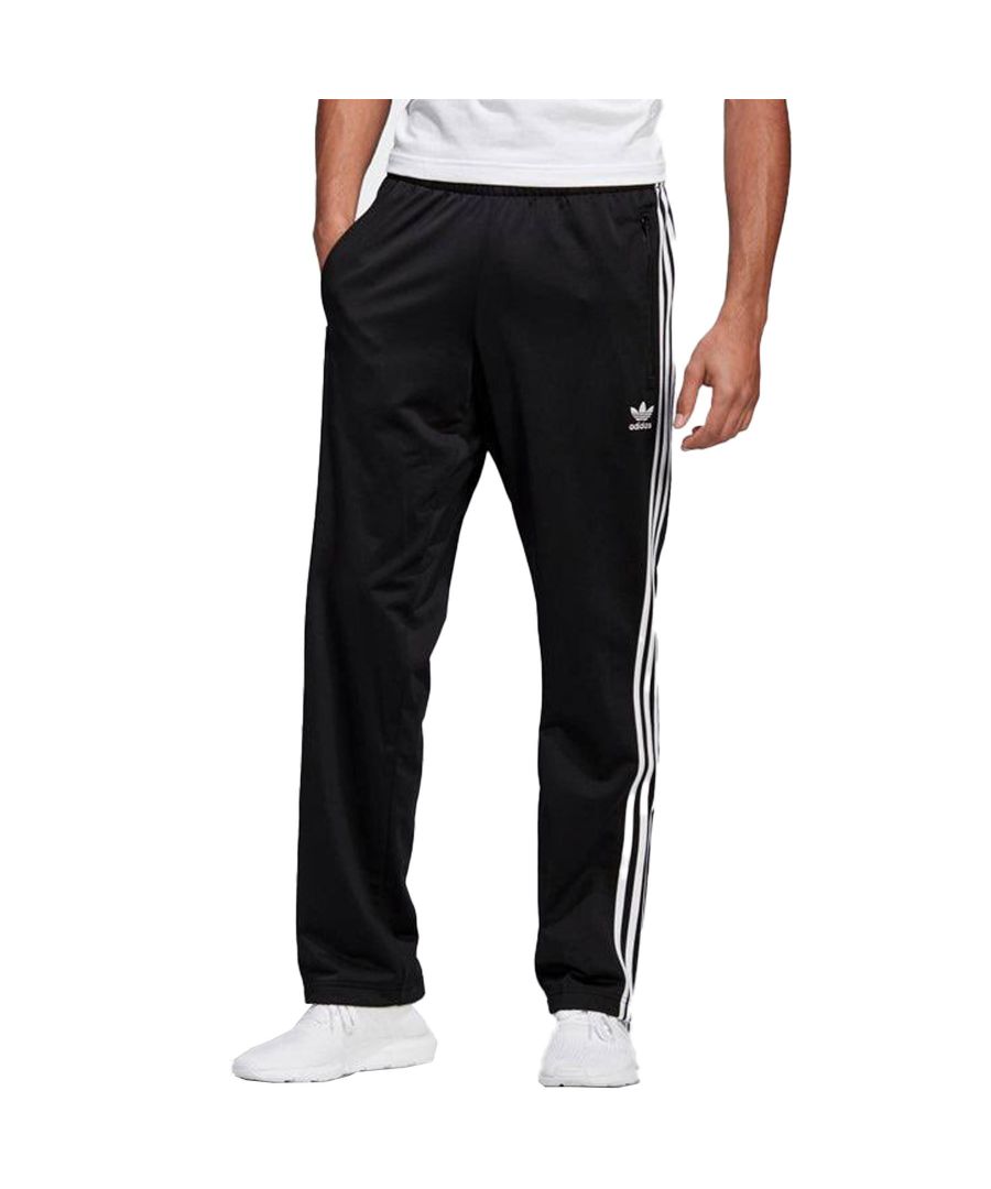 Adidas Mens Firebird Track Pants with an Elasticated waist and Ripped Cuffs along with a contrast 3 stripes Design on Legs, has a Regular Fit Size in Black colour, 100% Polyester Material.