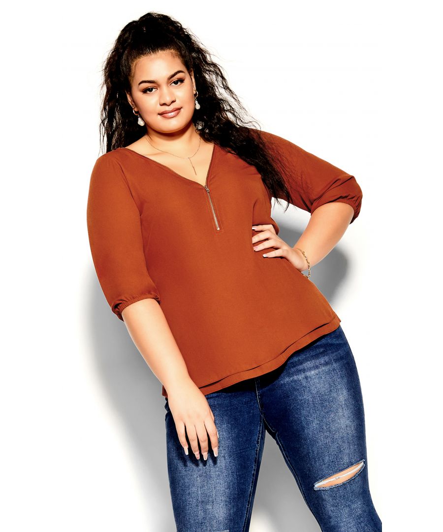 Add to your collection of versatile tops with the gorgeous Sexy Fling Elbow Sleeve Top. Flaunting an elegant copper hue, this chic blouse features a zip front, three-quarter sleeves and a comfortable relaxed fit for everyday wear. Key Features Include: - Workable zip neckline - Darted bust - Double layer front - 3/4 sleeve with elastic cuff - Relaxed fit - Hip length hemline - Lightweight woven fabrication Create an enviable office look with a high waist pencil skirt, glossy stockings and sleek pumps.