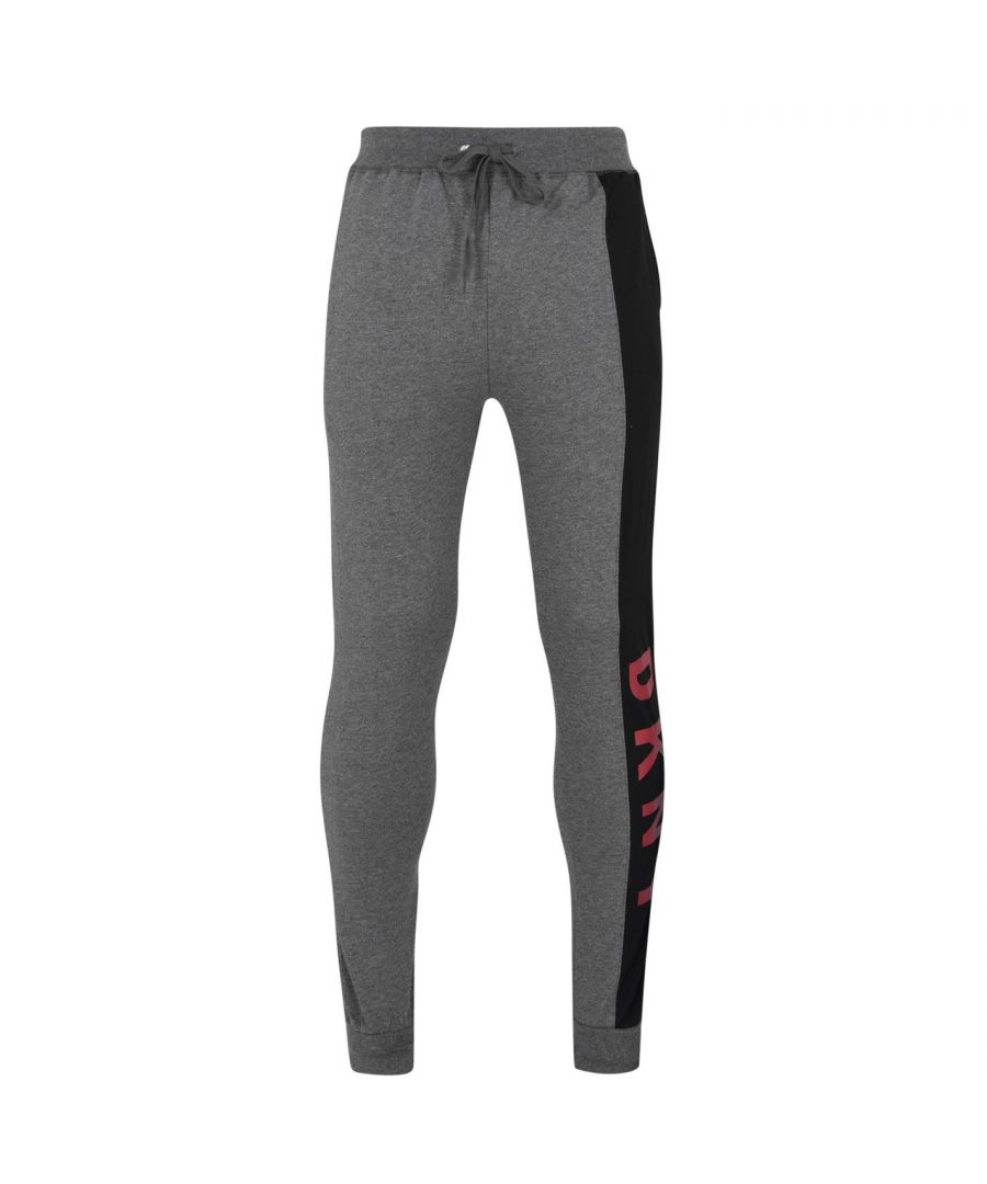 DKNY Large Logo Jogging Pants Enhance your collection with these DKNY Large Logo Jogging Pants. Constructed with an elasticated waistband and drawstring fastening for a secure fit, they feature ribbed cuffs for a classic look and two hand pockets for storage. These joggers are designed with a signature logo and are complete with DKNY branding.